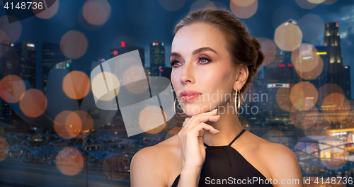 Image of beautiful woman in black wearing diamond jewelry