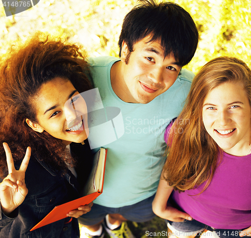 Image of cute group of teenages at the building of university with books 