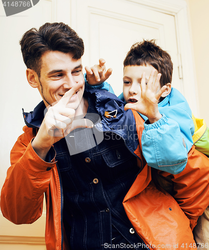 Image of young handsome father with his son fooling around at home, lifestyle people concept