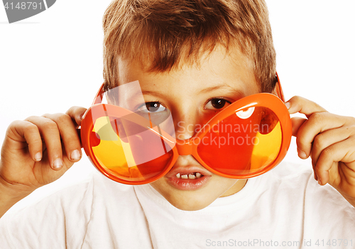 Image of little cute boy in orange sunglasses pointing isolated close up 