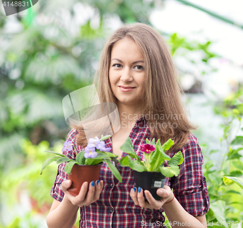 Image of smiling woman in greenhouse