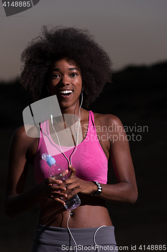 Image of african american woman jogging in nature