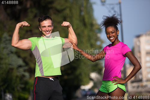 Image of portrait of young multietnic jogging couple ready to run