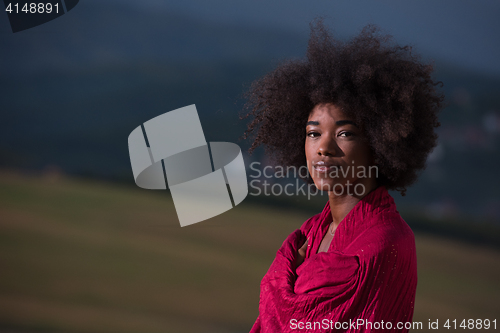 Image of outdoor portrait of a black woman with a scarf