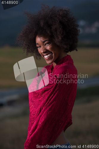 Image of outdoor portrait of a black woman with a scarf