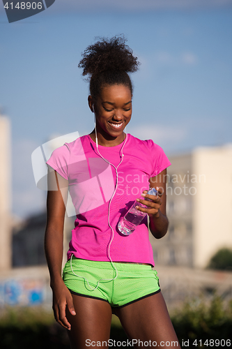 Image of african american woman running outdoors