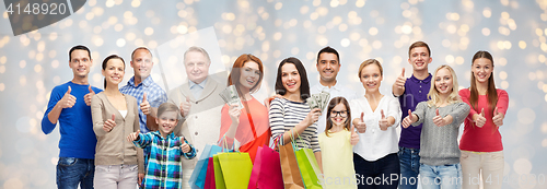 Image of happy people with shopping bags and money