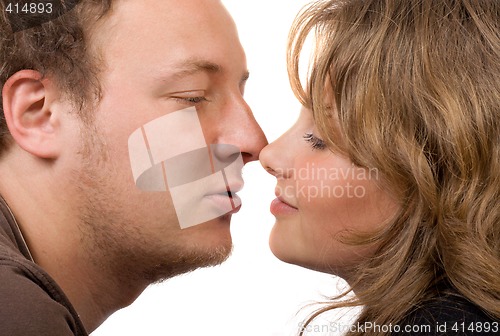 Image of Portrait of young kissing couple. Isolated on white