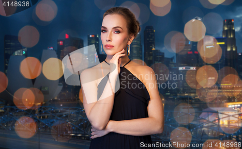 Image of beautiful woman in black wearing diamond jewelry