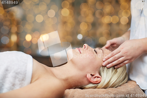 Image of close up of woman having face massage in spa