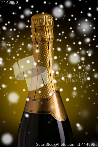 Image of close up of champagne bottle with golden label