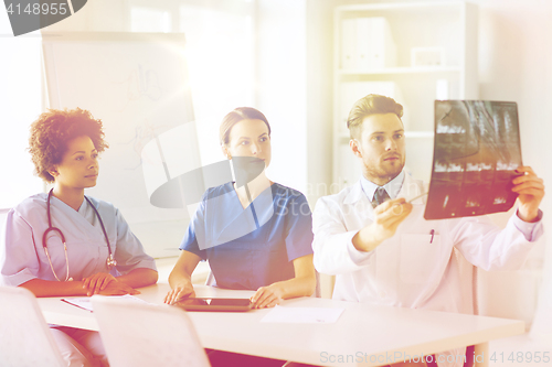 Image of group of doctors discussing x-ray image