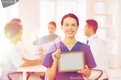 Image of happy doctor over group of medics at hospital