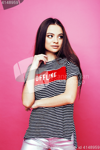 Image of young pretty teenage woman emotional posing on pink background, fashion lifestyle people concept