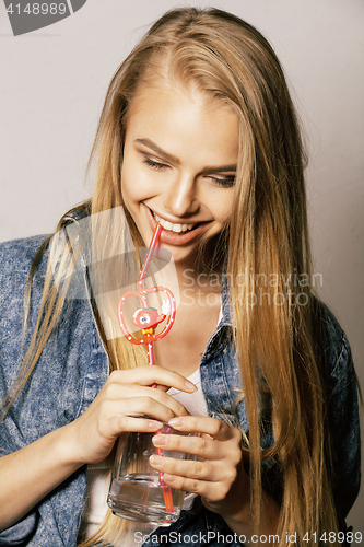 Image of young blond woman on white backgroung gesture thumbs up, isolate