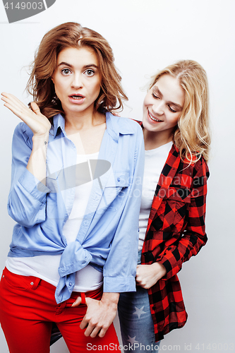 Image of two pretty blond woman having fun together on white background, mature mother and young teenage daughter, lifestyle people concept