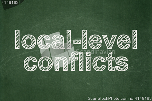 Image of Politics concept: Local-level Conflicts on chalkboard background