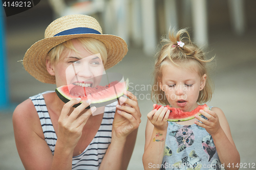 Image of Mother And Daughter Enjoying Slices Of WaterMelon