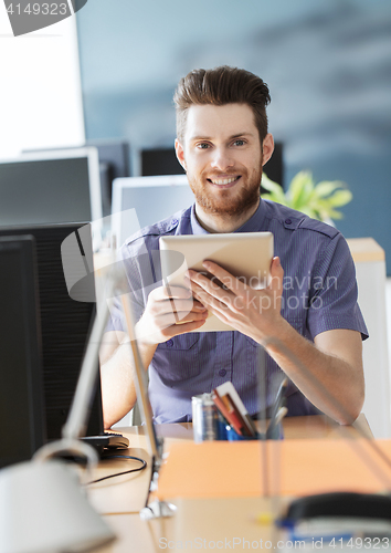 Image of happy creative male office worker with tablet pc