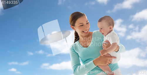 Image of happy young mother with little baby over blue sky