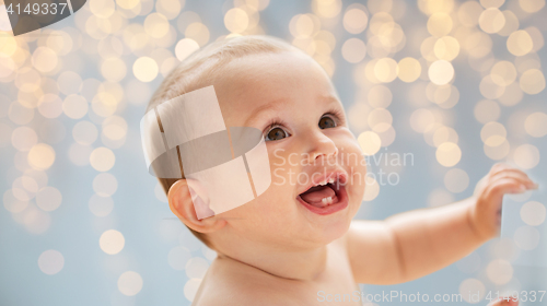 Image of happy little baby boy or girl looking up