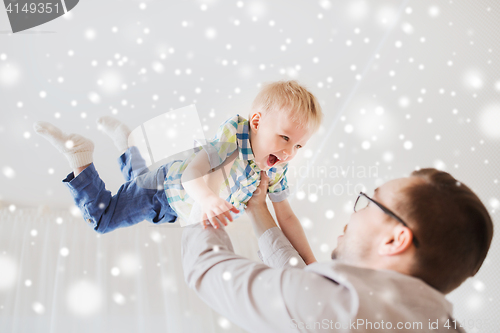 Image of father with son playing and having fun at home