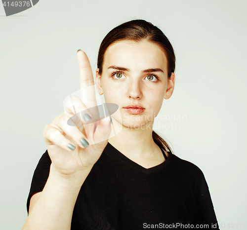 Image of young pretty girl pointing on white background, business science concept