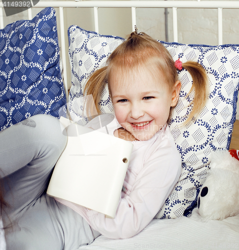 Image of little cute girl laying in bed happy smiling, lifestyle people concept