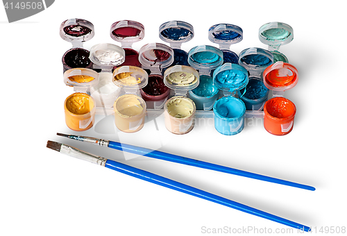 Image of Set of colorful acrylic paints in jars and two brushes