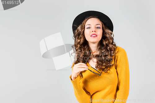 Image of The girl in glasses and hat