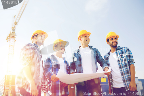 Image of group of builders with tablet pc and blueprint