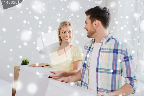 Image of smiling couple with big boxes moving to new home