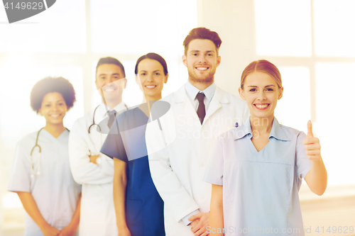 Image of happy doctors showing thumbs up at hospital