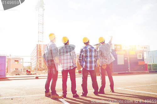 Image of group of builders in hardhats outdoors