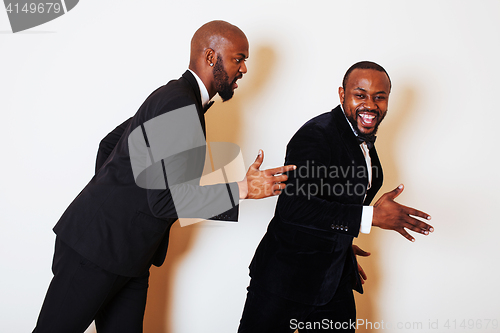 Image of two afro-american businessmen in black suits emotional posing, g