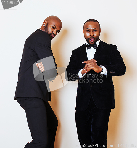 Image of two afro-american businessmen in black suits emotional posing, g