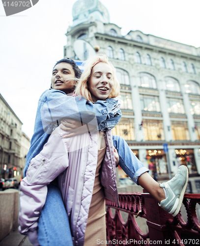 Image of Two teenage girls infront of university building smiling, having fun traveling europe, lifestyle people concept