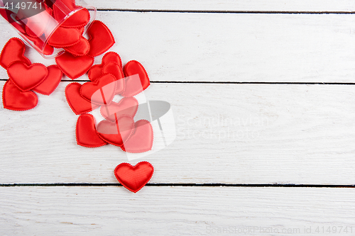 Image of Red hearts on a white wood background