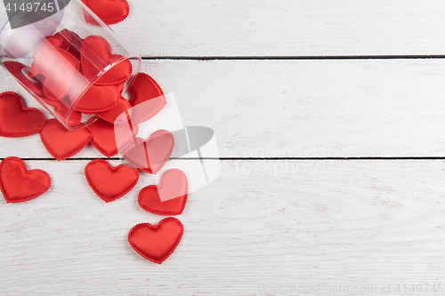 Image of Red hearts on a white wood background