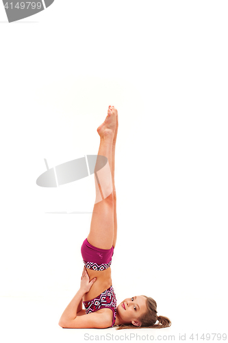 Image of The teenager girl doing gymnastics exercises isolated on white background