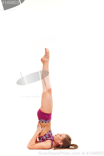 Image of The teenager girl doing gymnastics exercises isolated on white background