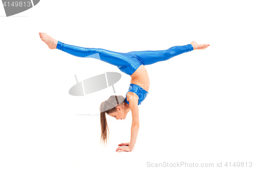 Image of The teenager girl doing gymnastics exercises isolated on white background