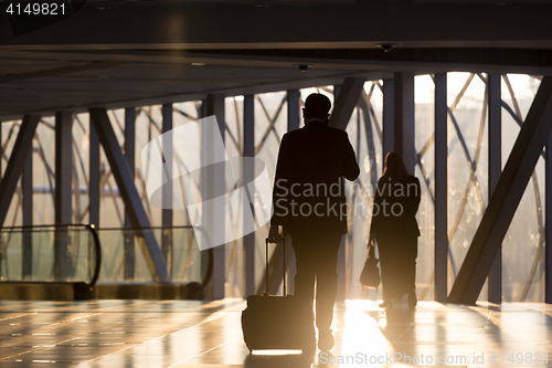 Image of Businessman at airport corridor walking to departure gates.