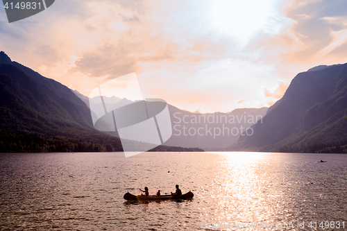 Image of Family rowing in canoe boat on beautiful lake Bohinj, Slovenia.