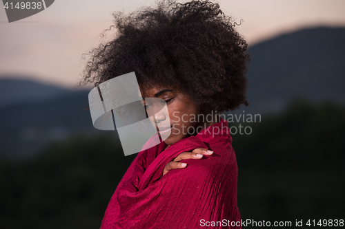 Image of outdoor portrait of a black woman with a scarf