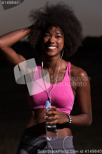 Image of african american woman jogging in nature