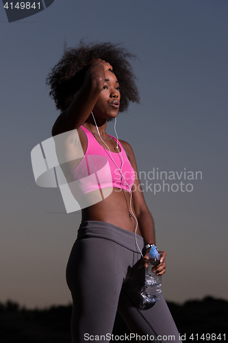 Image of african american woman jogging in nature