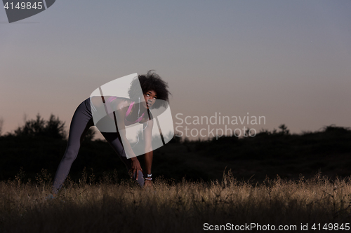 Image of black woman is doing stretching exercise relaxing and warm up