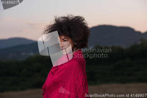 Image of outdoor portrait of a black woman with a scarf