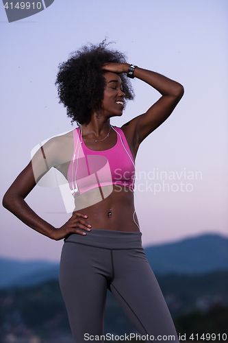 Image of portrait of african american woman jogging in nature